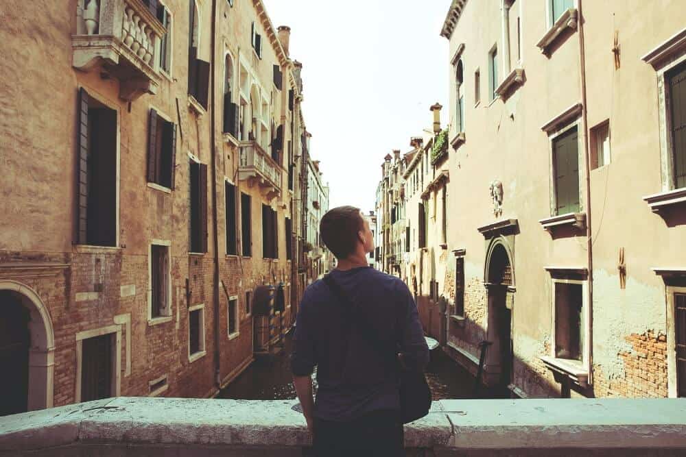  A male tourist in Venice fighting off loneliness whehn travelling solo by doing something he enjoys