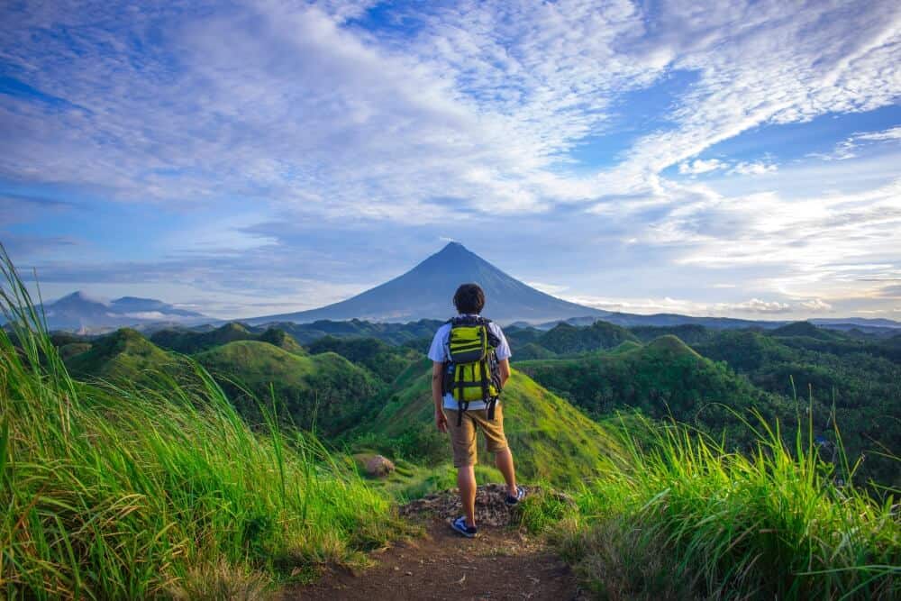 Travelling Alone While in a Relationship: Can You Do It? 1 man looking at mountain for solo travel and relationships