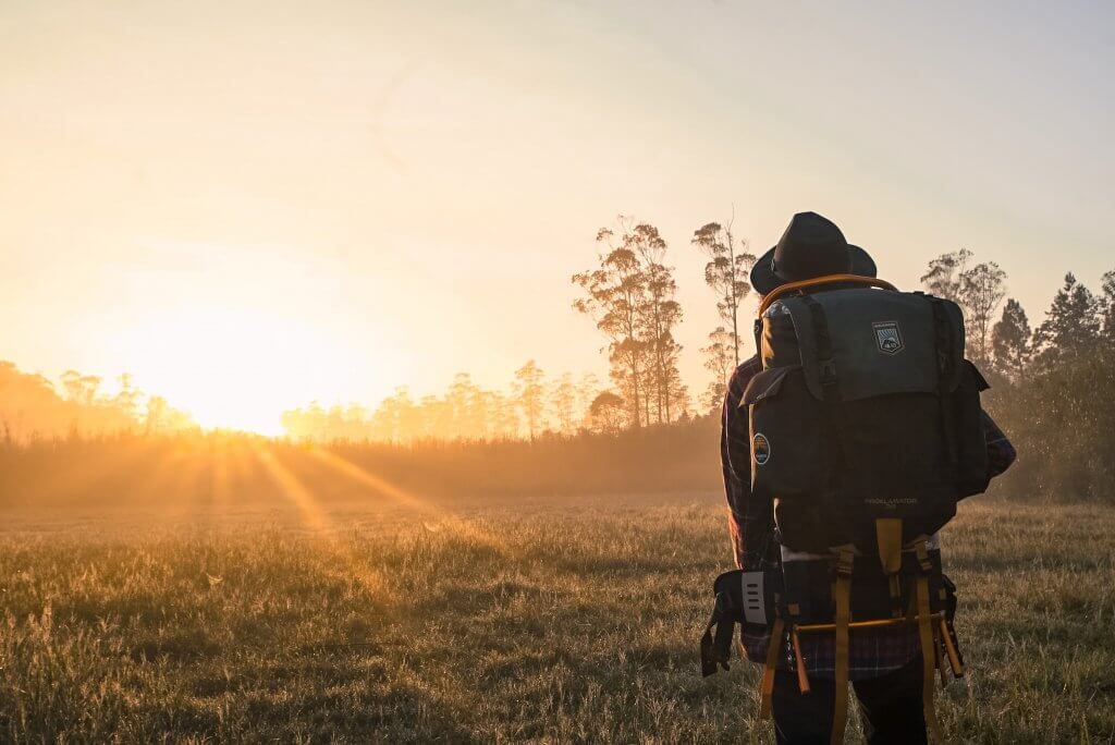Climate Change and Travel: Is It Time to Change Our Flying Habits? 8 climate change and travel backpacker and sunset