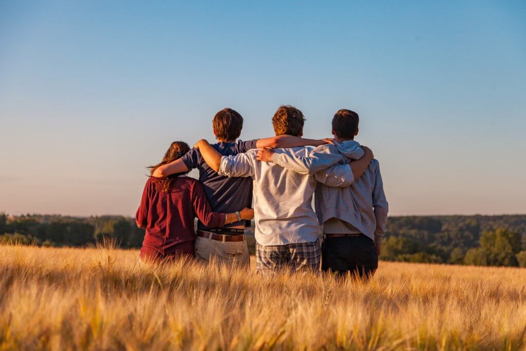 Why Voluntourism Does More Harm Than Good 4 group of people in a field