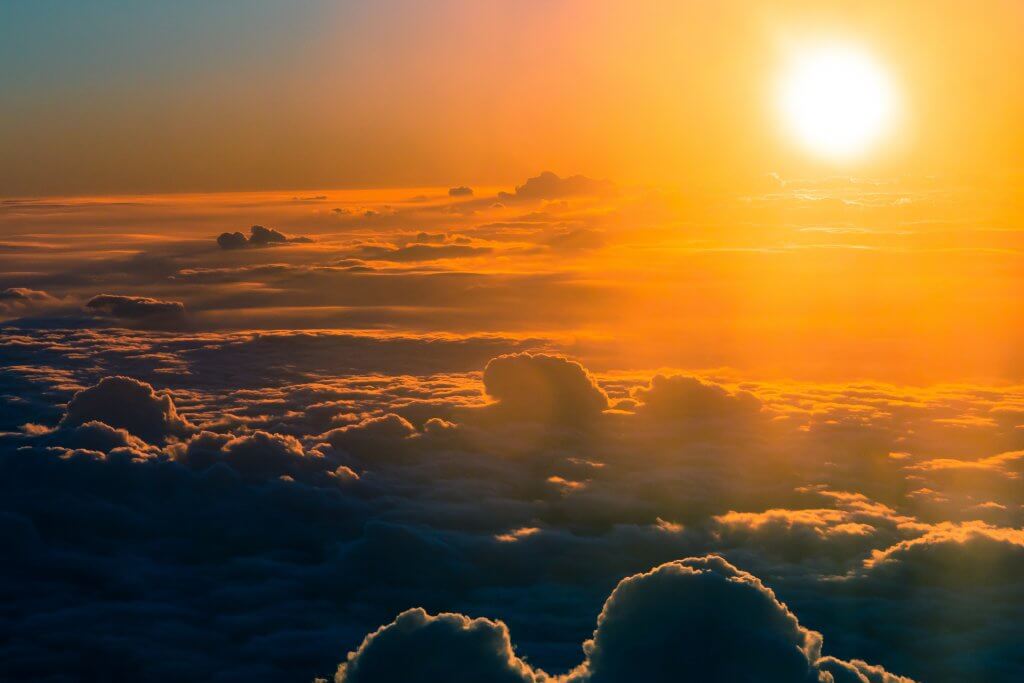 Climate Change and Travel: Is It Time to Change Our Flying Habits? 2 sunshining over clouds