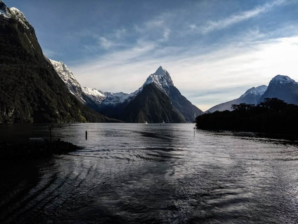 Mitre Peak in Milford Sound. Mountains with a body of water in front. 
