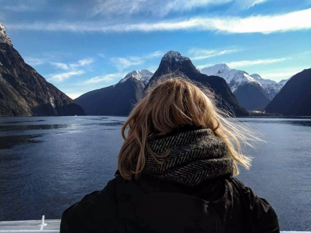 Back of girl's head with mountains behind on a sunny day. 