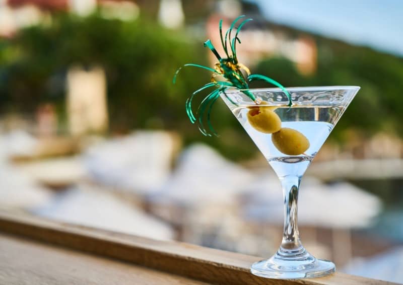 Martini with olive on a ledge