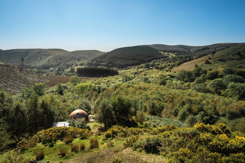 10 Sustainable Secluded Places to Stay in the UK 6 The Red Kite Conkers make a fantastic secluded stay. Image of the conker surrounded by green hills.