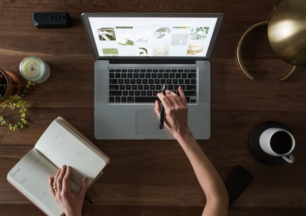 Person researching on a laptop for how to travel solo. 