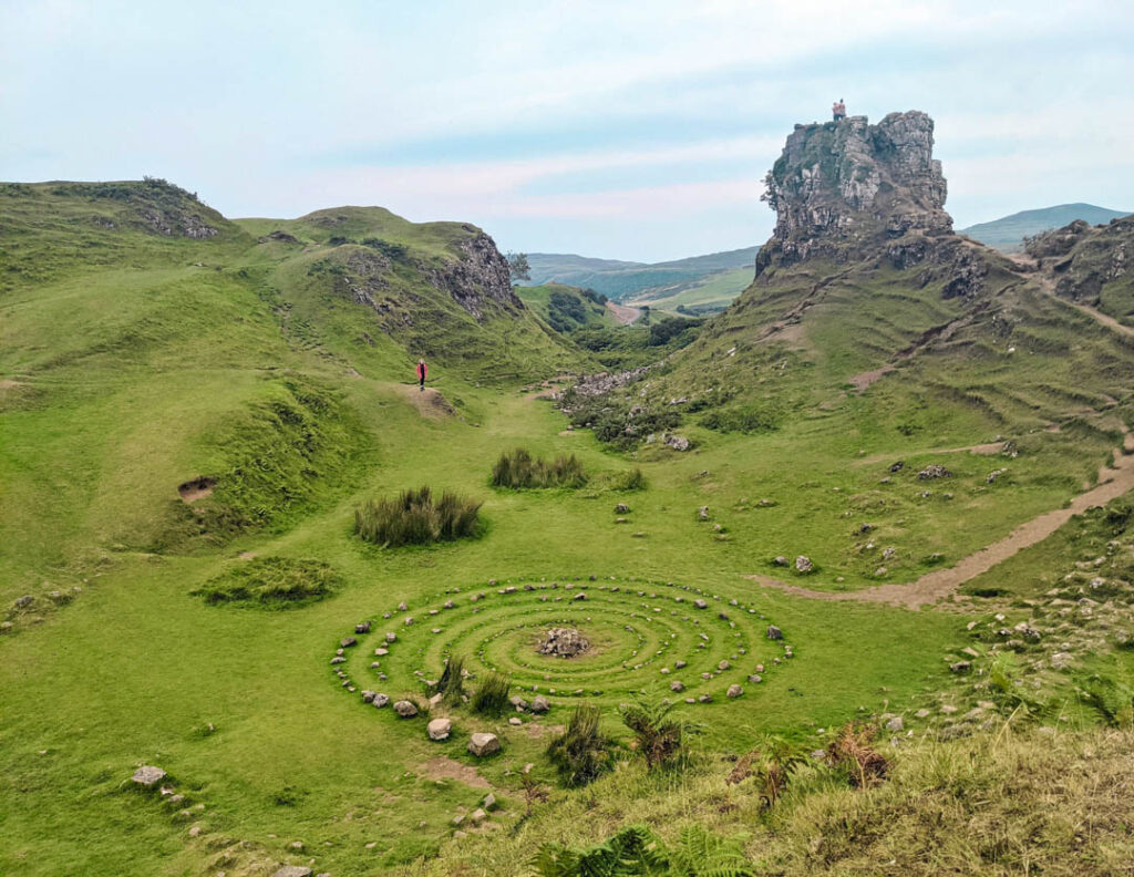 The Fairy Glen on the Isle of Skye and a girl in a red coat in the background.  
