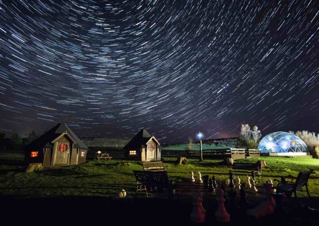 Skyewalker's Jedi Huts on the lawn under a starry sky. 