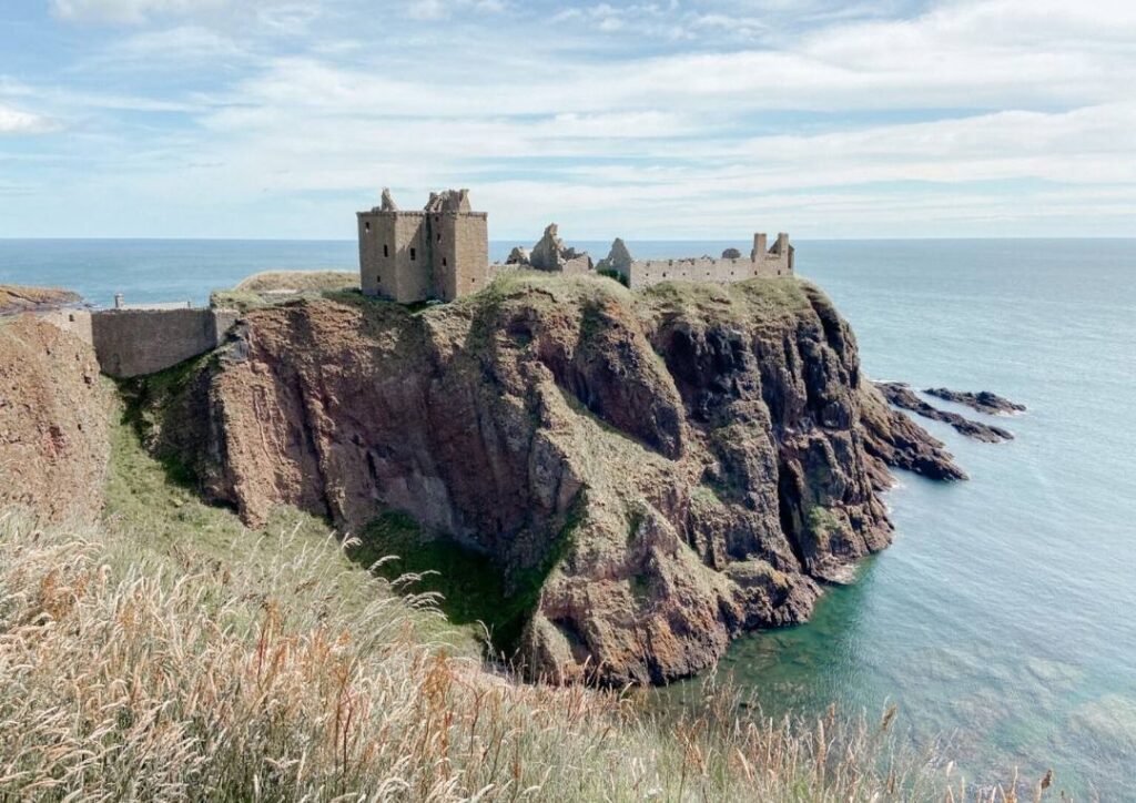 Dunnottar Castle in Aberdeenshire, Scotland sitting on the rocks by the sea. 