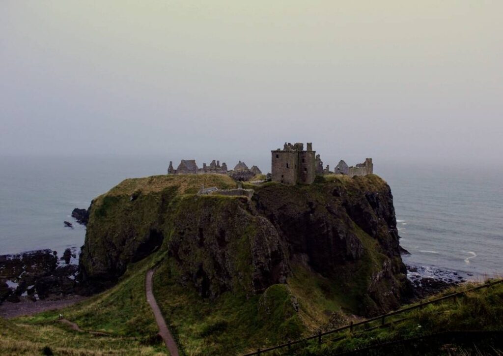 Castle ruins on a hill with the sea behind at Stonehaven in Scotland. 