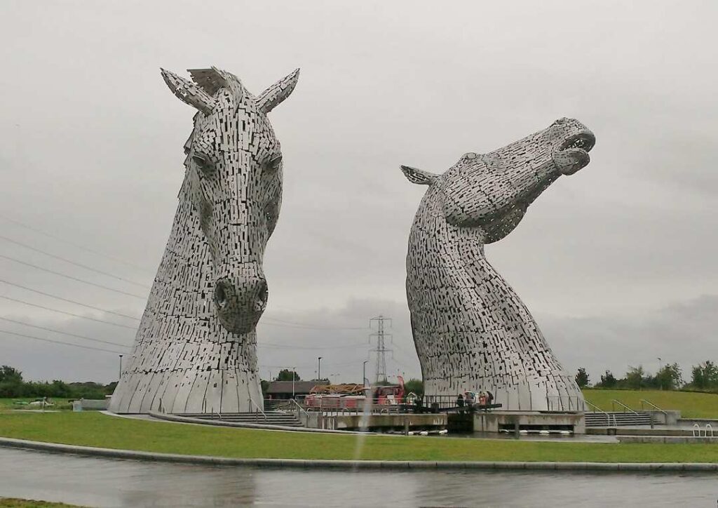 Two silver horses heads - the Kelpies in Scotland's Falkirk, one of the best day trips from Edinburgh by train or bus.