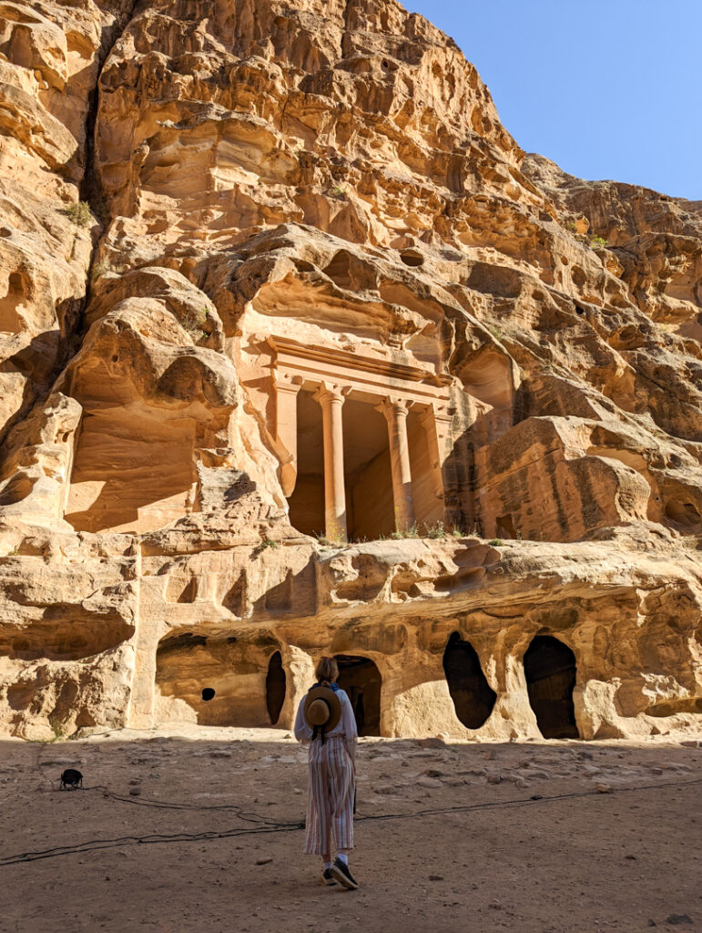 The Best Jordan Packing List: All The Essentials You Need in 2024 23 A girl standing in front of Little Petra in Jordan.