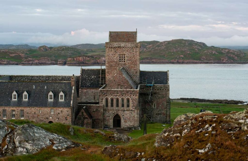 Iona Abbey with Mull behind on a grey day in Scotland. 