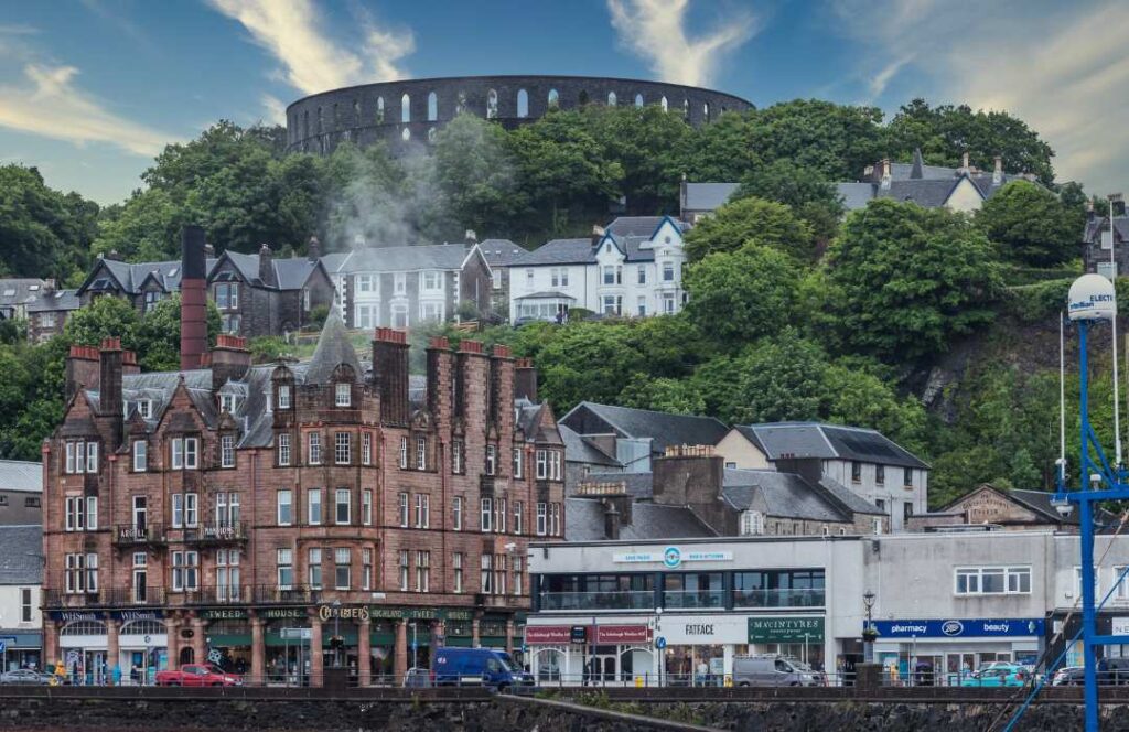 View of Oban with McCaig's Tower on the hill above. Known as the Seafood Capital, Oban is one of the best places to visit on the west coast of Scotland. 