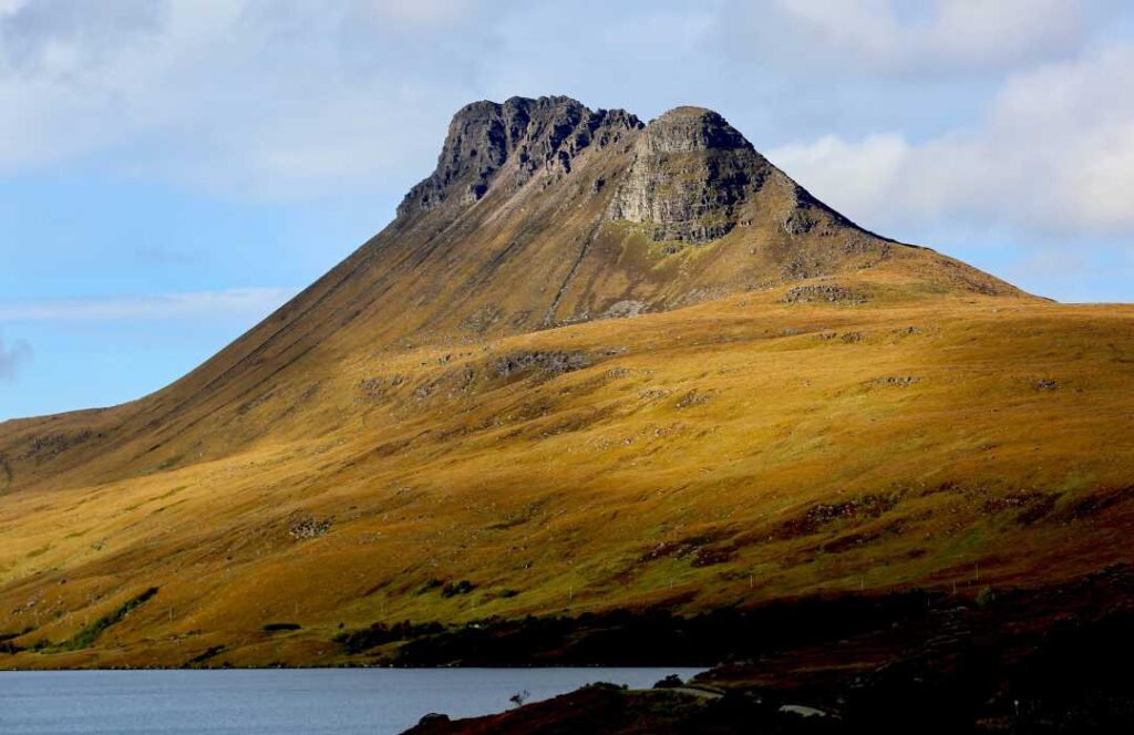A mountain rises up from the coast near Ullapool on the northwest coast of Scotland. 