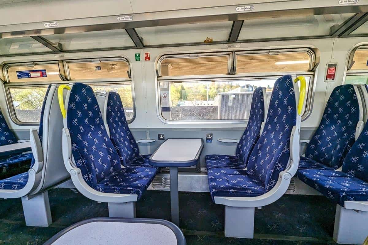 13 Best Places to Visit in Scotland by Train 17 The interio of a ScotRail train. It's empty and the seats are blue.