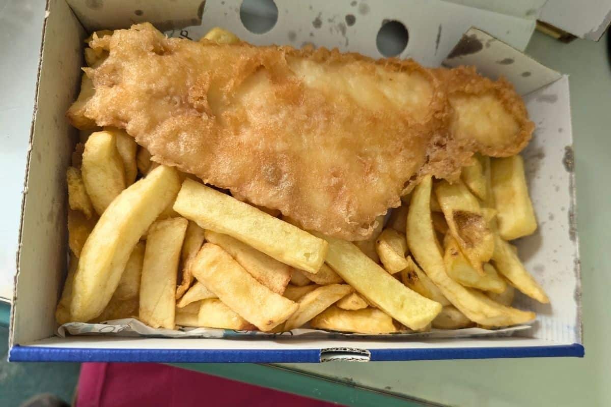 An open box of golden fish and chips from Oban Fish and Chip Shop. 