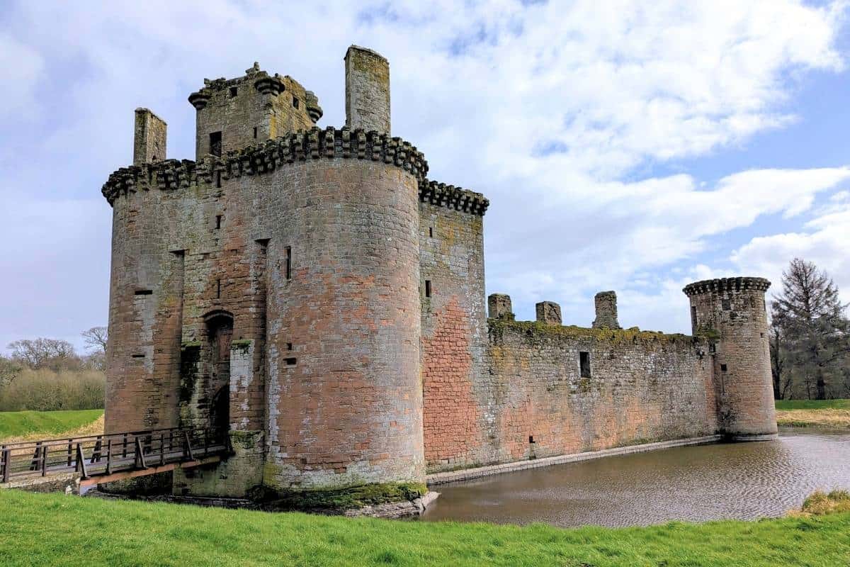 The ruin of a castle surrounded by a moat in Dumfries and Gaolloway, one of the most underrated regions in Scotland. 