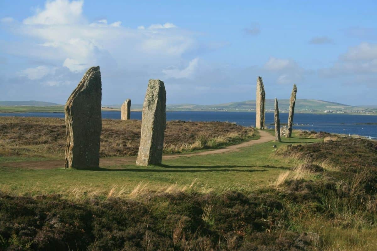 Ancient standing stones line a walking path on the coast. The Ring of Brodgar on Orkney. 