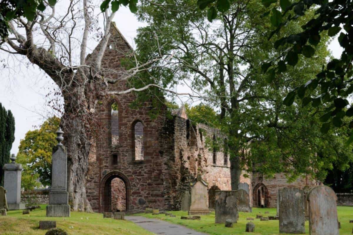 10 Easy Day Trips from Inverness Without a Car 4 The old ruined priory in Beauly surrounded by gravestones and trees.