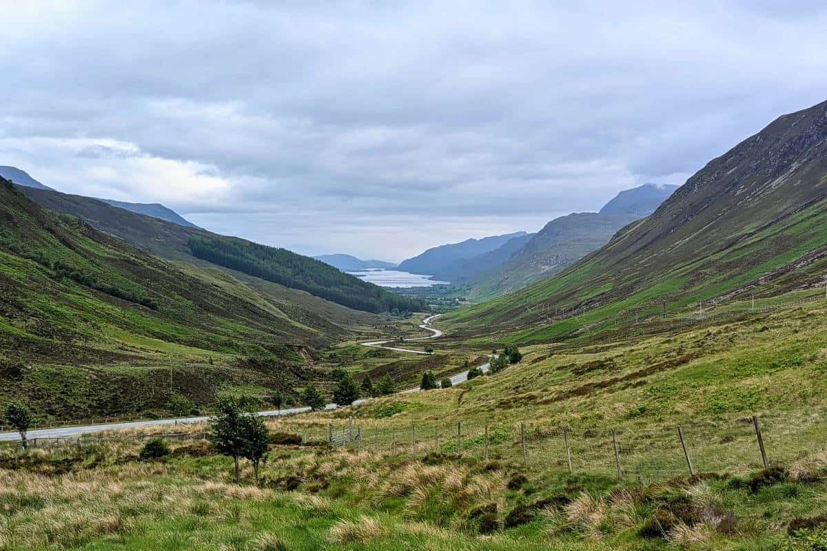 10 Easy Day Trips from Inverness Without a Car 15 A road snaking town between hills and mountains ending in a loch at the bottom.