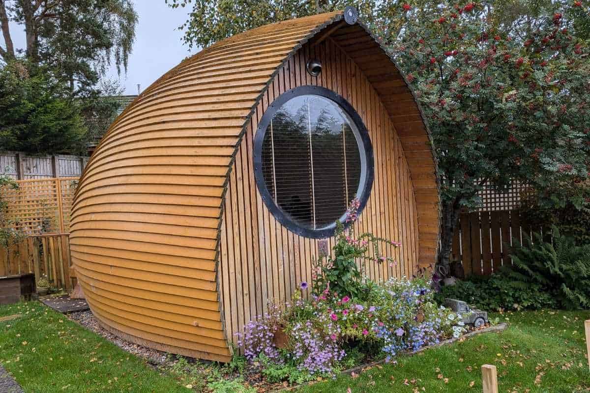 Where to Stay in Scotland Without a Car: Best Areas + Hotels 14 A glamping pod wuth flowers outside it in Aviemore for where to stay in Scotland without a car.