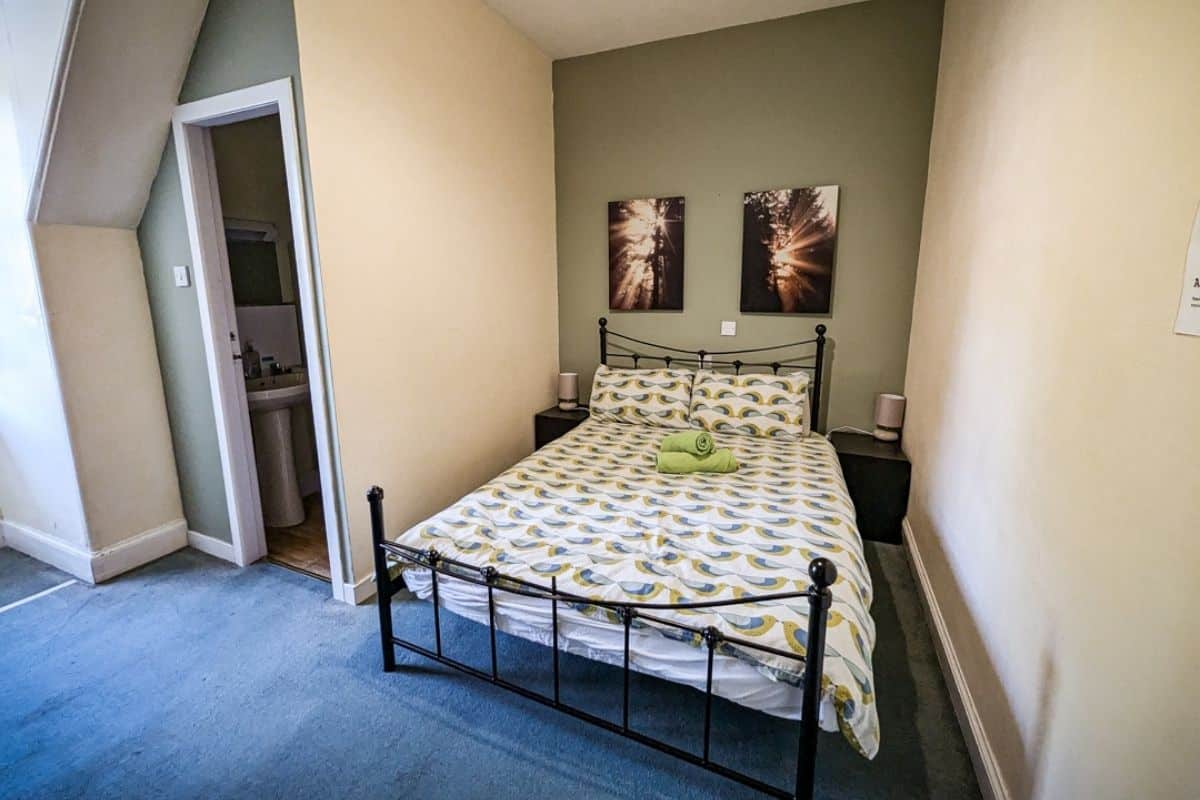 Where to Stay in Scotland Without a Car: Best Areas + Hotels 16 A simple but clean room with a bed and an ensuite bathroom at Pitlochry Backpackers.