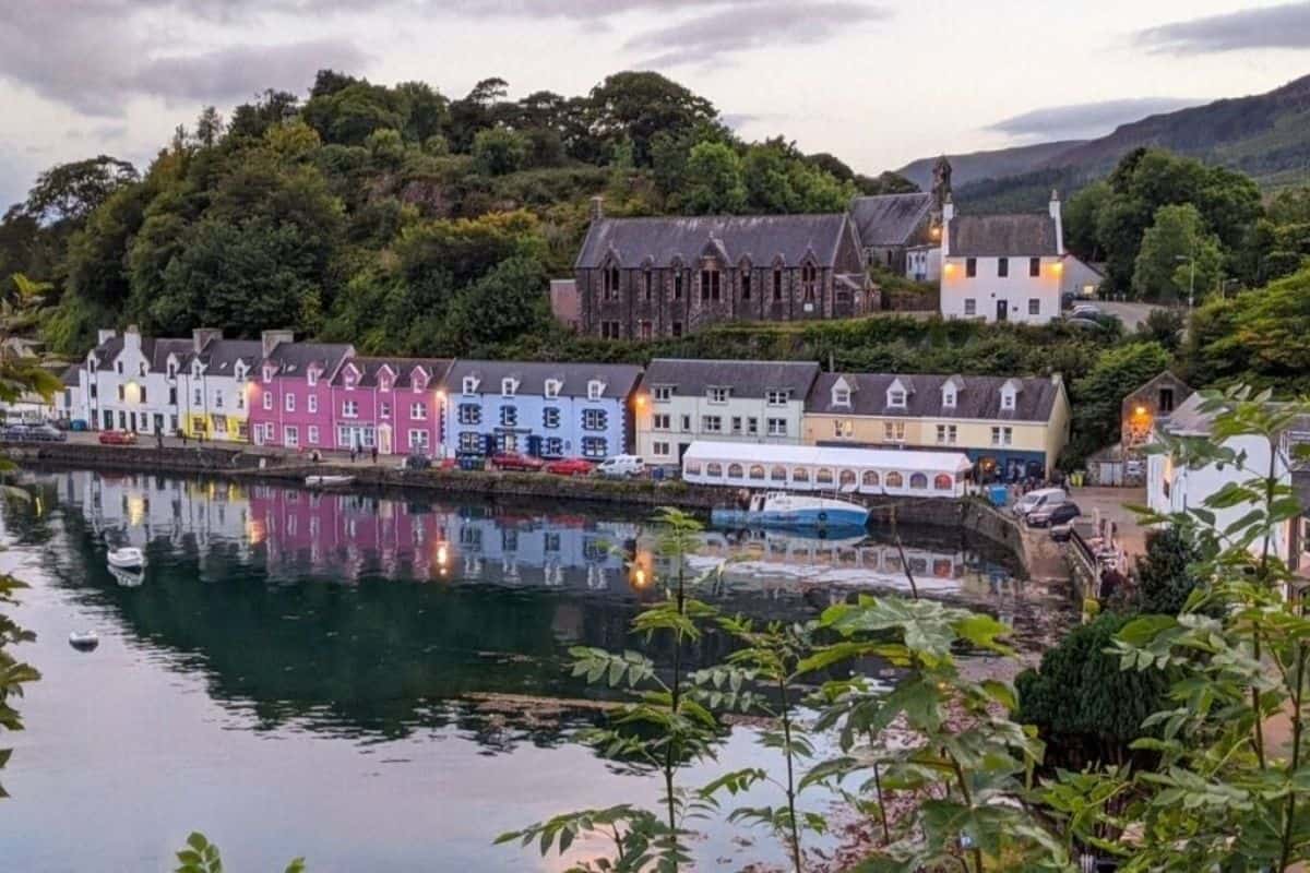 Where to Stay in Scotland Without a Car: Best Areas + Hotels 17 A colourful harbourfront at dusk. Portree for where to stay in Scotland without a car.