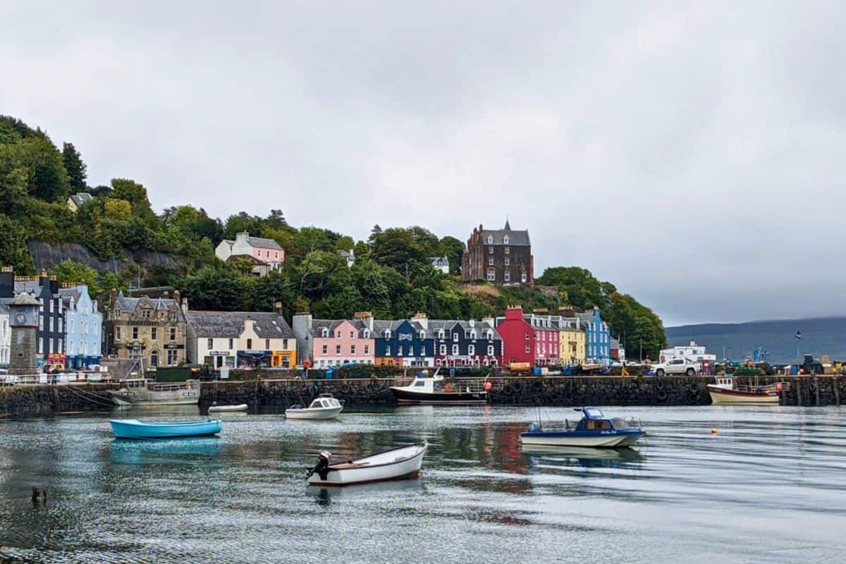 Where to Stay in Scotland Without a Car: Best Areas + Hotels 19 A colourful harbourfront with boats bobbing on the water. Tobermory on the Isle of Mull.