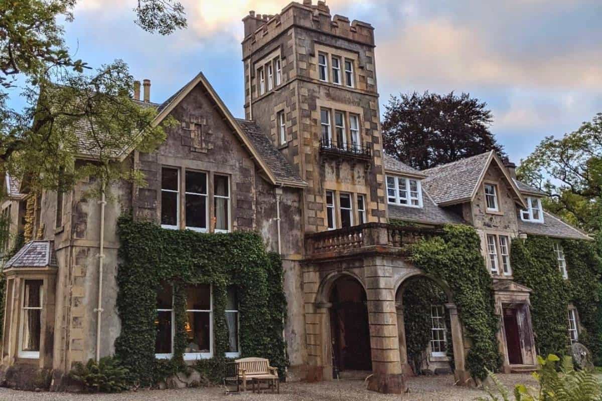 Where to Stay in Scotland Without a Car: Best Areas + Hotels 18 A grand old manor house with ivy and large windows surrounded by trees. Viewfield House in Portree.